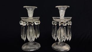 A PAIR OF EARLY C19TH. CUT GLASS CANDLESTICKS WITH DROP LUSTRES HEIGHT 23CM.