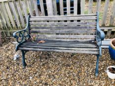 A GARDEN BENCH WITH HEAVY CAST ENDS AND WOODEN SLATS