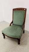 AN EDWARDIAN OAK FRAMED GREEN VELOUR NURSING CHAIR