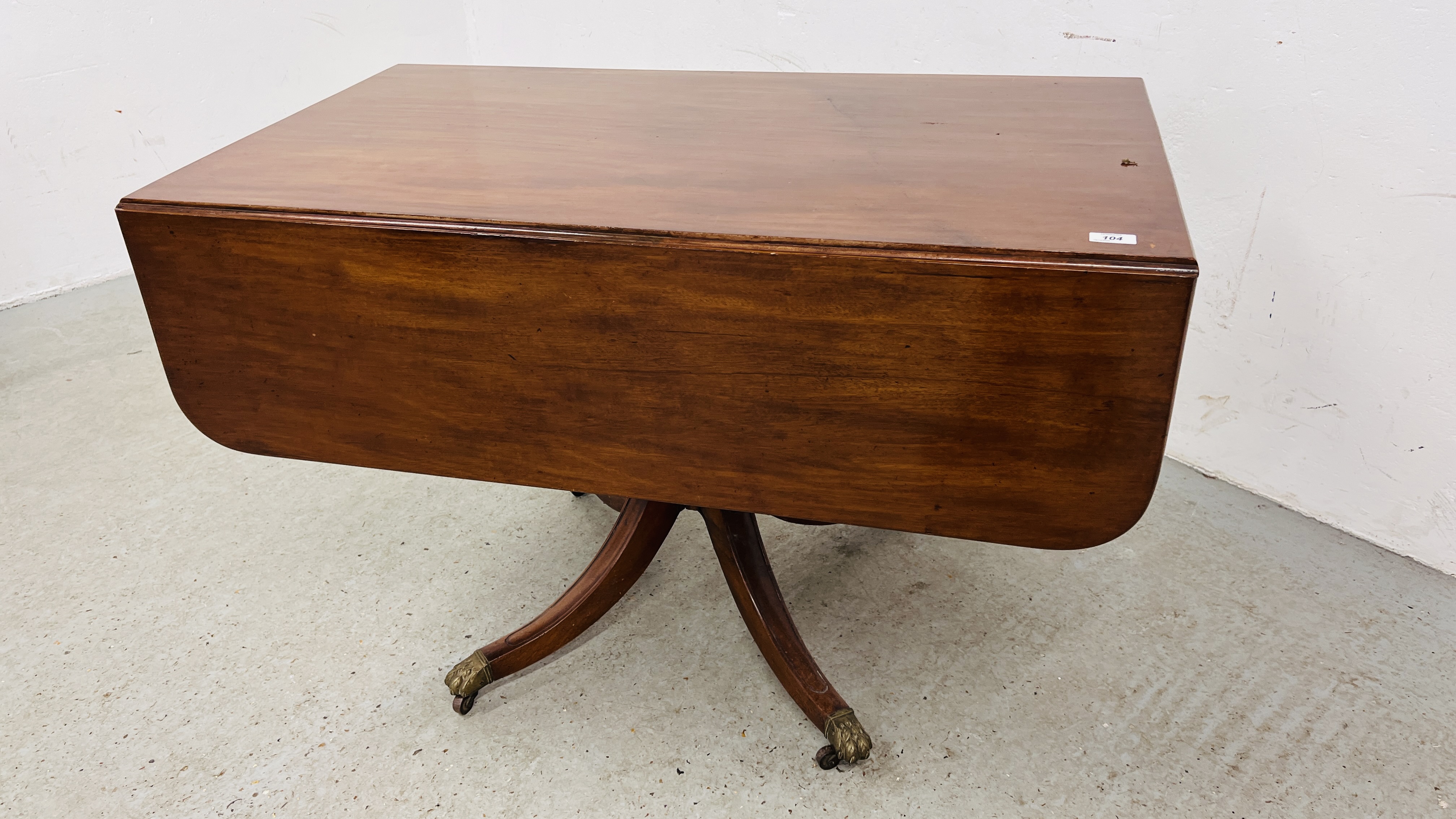 A REGENCY MAHOGANY DROP LEAF PEDESTAL TABLE, THE TWO DRAWERS ABOVE OUTSWEPT LEGS,