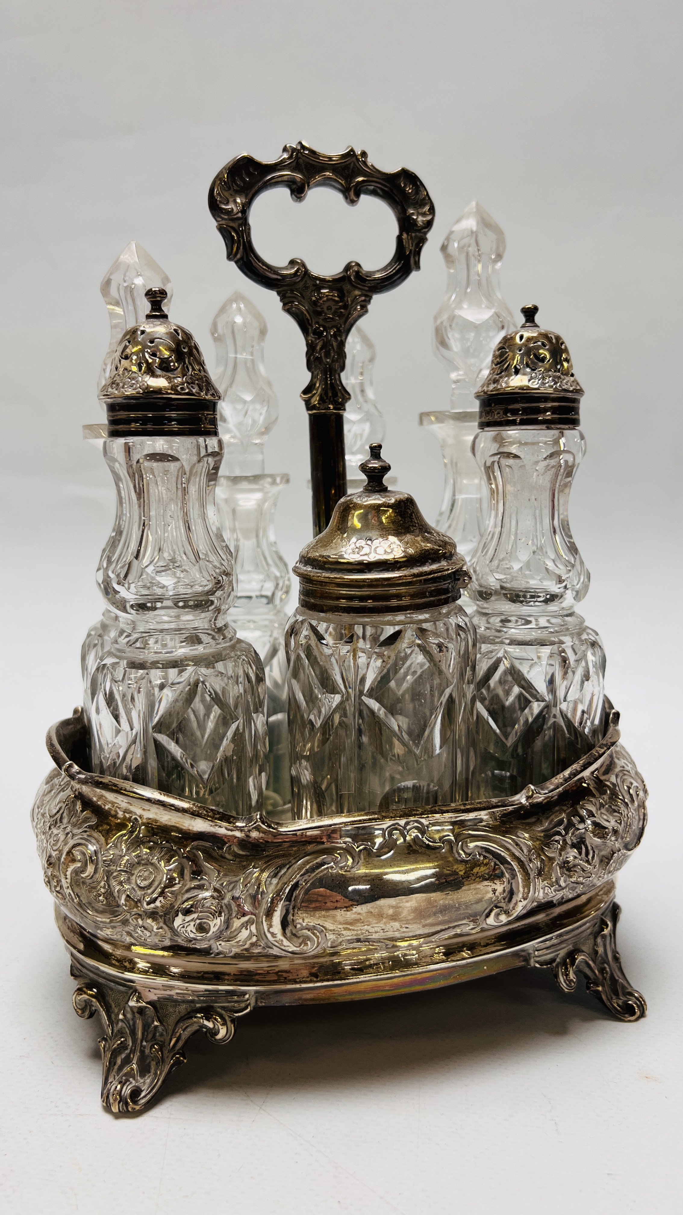 AN IMPRESSIVE SILVER EIGHT BOTTLE CRUET, THREE OF WHICH HAVE SILVER TOPS,