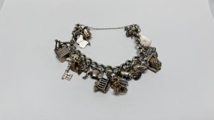 VINTAGE SILVER CHARM BRACELET WITH APPROX 25 SILVER AND WHITE METAL CHARMS