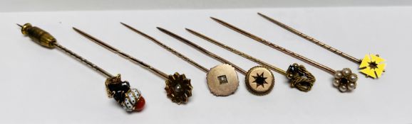 A GROUP OF SEVEN VINTAGE STICK/TIE PINS TO INCLUDE STONE SET, AND A ENAMELLED BUST EXAMPLE, ETC.