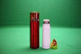 A WHITE 500ML BULLET FLASK ALONG WITH OVERSIZED 12G CARTRIDGE FLASK IN RED