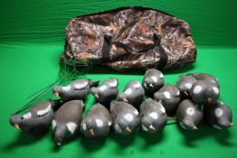 A GROUP OF 15 FULL BODY PIGEON DECOYS ALONG WITH 6 GREEN METAL STANDS AND LARGE CAMOUFLAGE HOLDALL