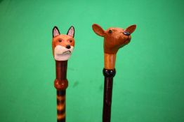 2 X HAND CRAFTED SHOOTING STICKS WITH CARVED AND PAINTED ANIMAL HEADS OF FOX AND DEER