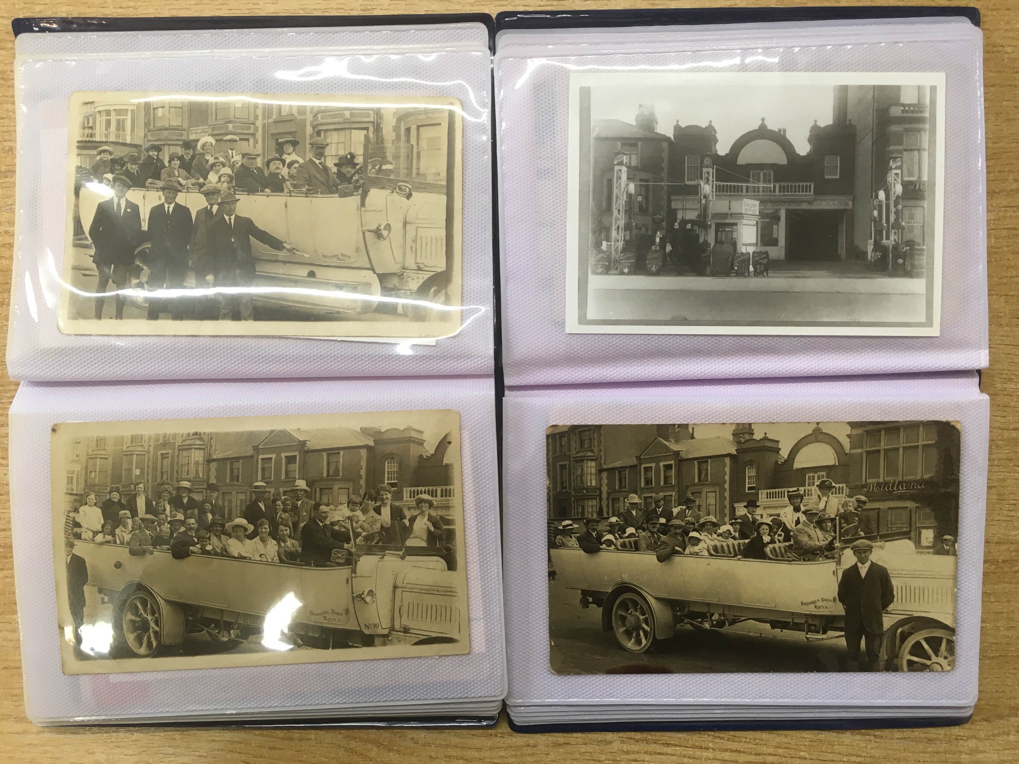 A COLLECTION IN TWO FOLDERS OF POSTCARDS SHOWING CHARABANCS AT RHYL, MAINLY RPs WITH DAY TRIPPERS,