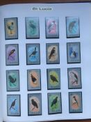 BOX WITH AN EXTENSIVE COLLECTION OF BIRD THEMATICS IN FIVE VOLUMES, MANY MNH SETS,