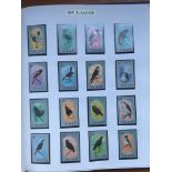 BOX WITH AN EXTENSIVE COLLECTION OF BIRD THEMATICS IN FIVE VOLUMES, MANY MNH SETS,