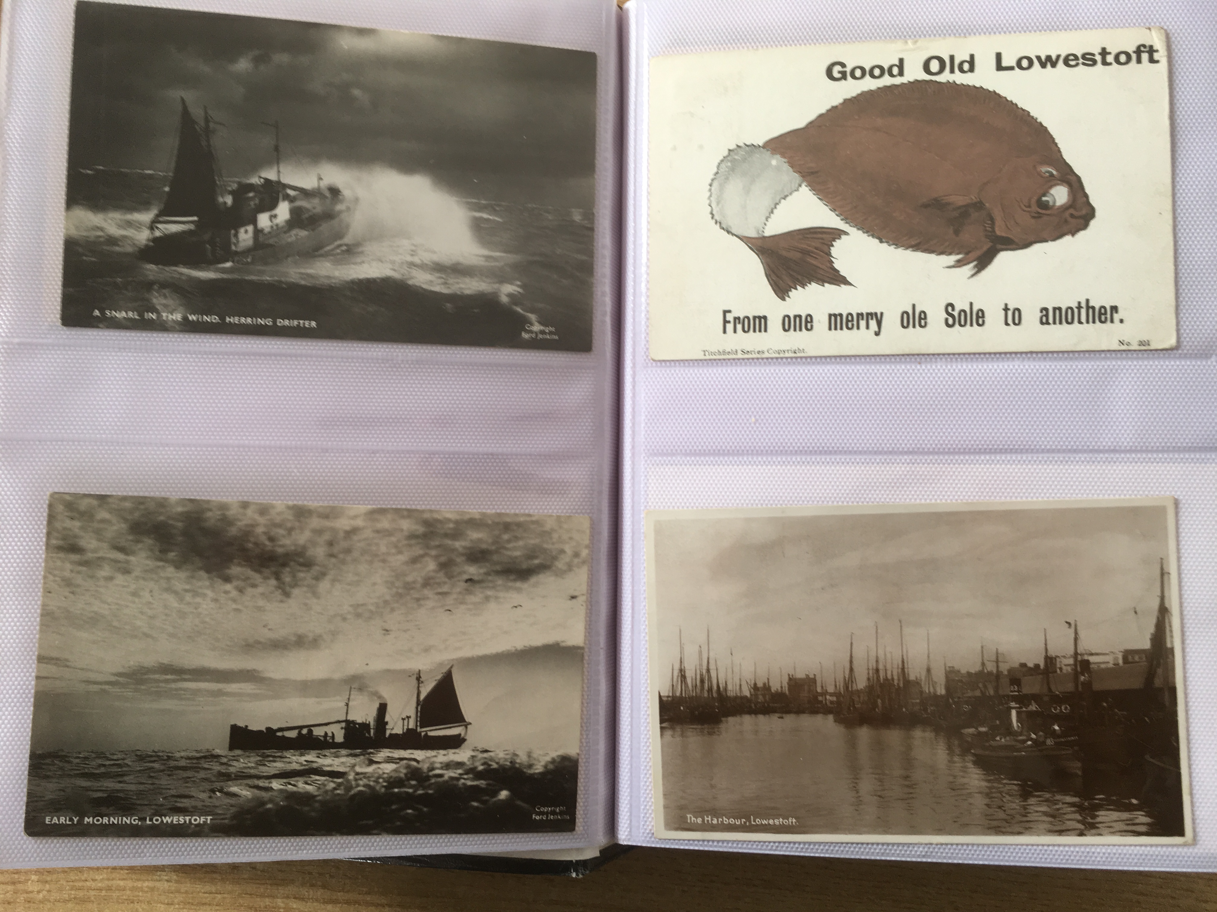 SUFFOLK: ALBUM WITH A COLLECTION OF LOWESTOFT FISHING INDUSTRY POSTCARDS, HARBOUR, TRAWLERS,