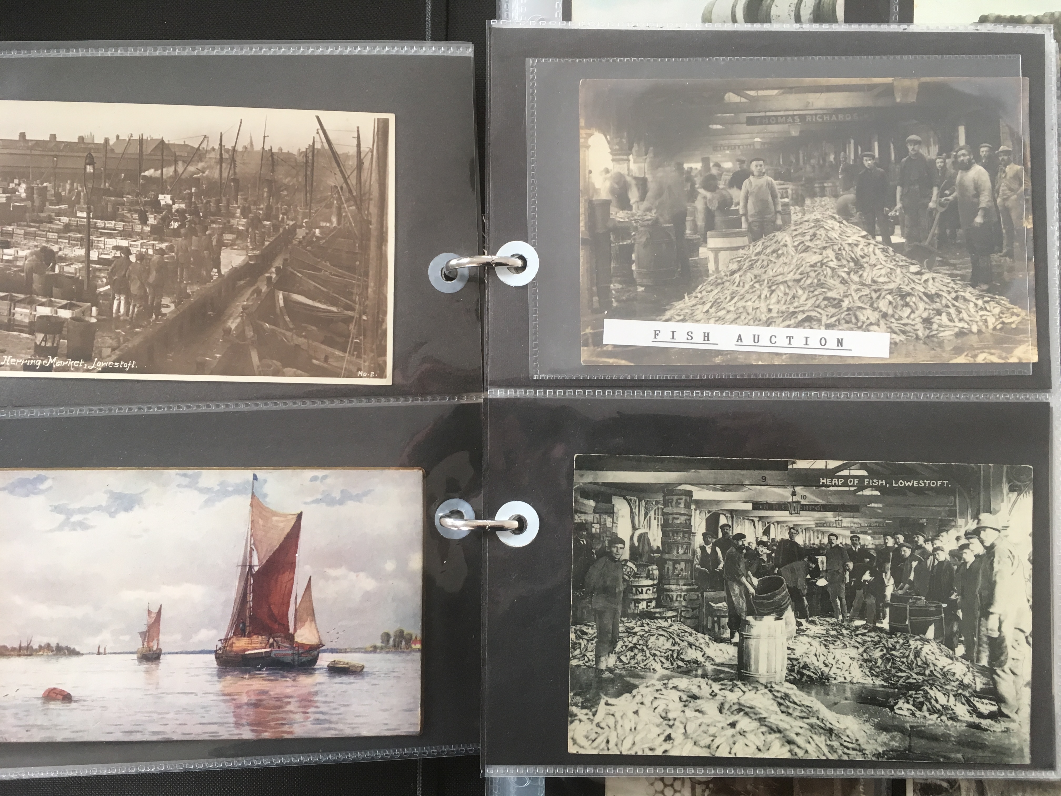 SUFFOLK: ALBUM WITH A COLLECTION OF LOWESTOFT FISHING INDUSTRY POSTCARDS, HARBOUR, DRIFTERS,