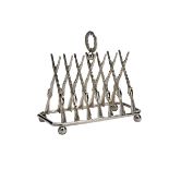 A TOAST RACK IN THE FORM OF CROSSED GUNS, the rack formed with triangulated percussion guns