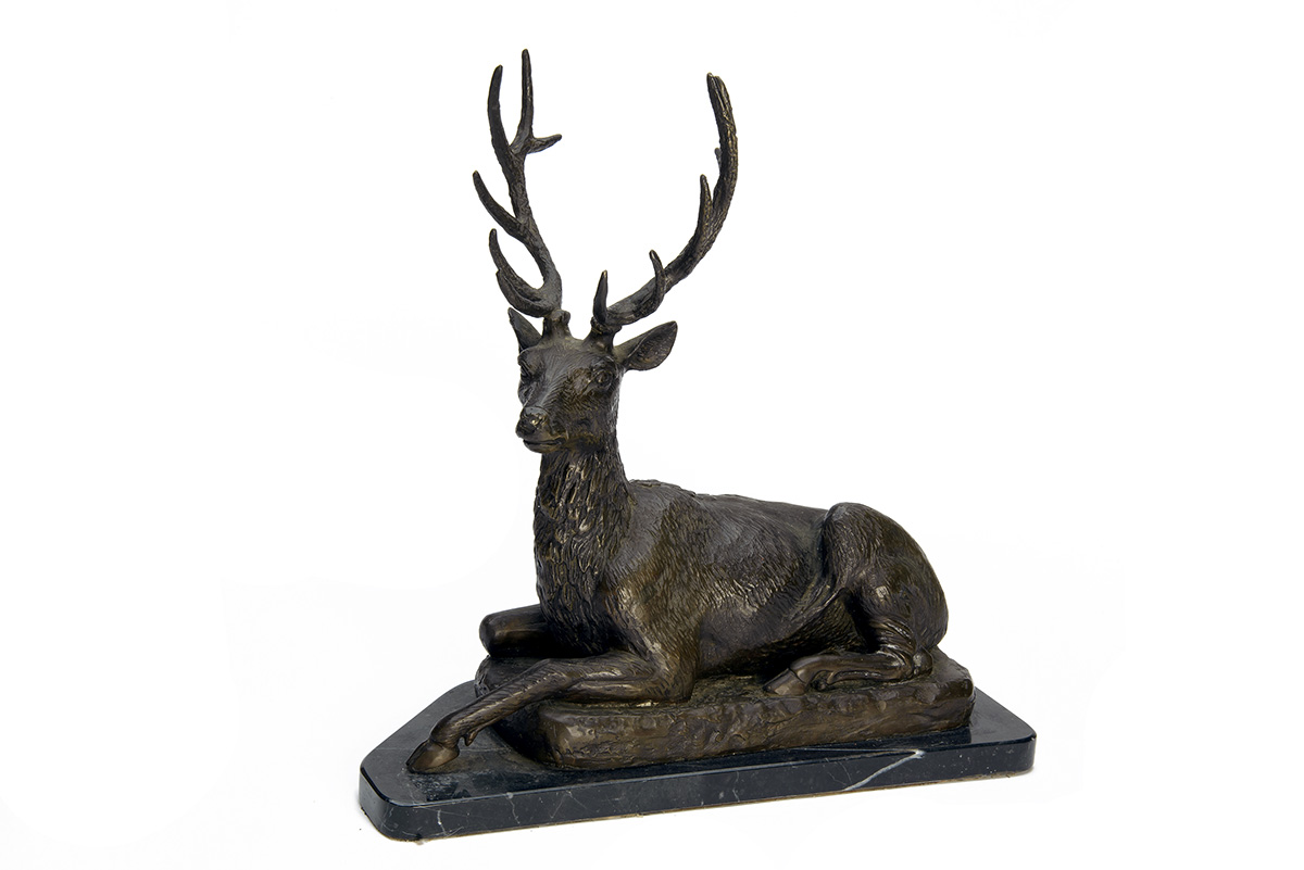 A BRONZE SCULPTURE OF A RESTING TWELVE-POINT STAG, mounted on a marble plinth, measuring approx.