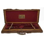 HENRY ATKIN LTD. A BRASS-CORNERED OAK AND LEATHER DOUBLE GUNCASE, fitted for 28in. barrels (could