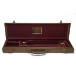 A LEATHER LIGHTWEIGHT SINGLE GUNCASE, fitted for 27in. barrels, the interior lined with maroon