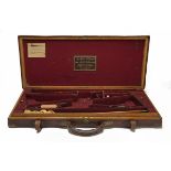 HENRY ATKIN (FROM PURDEY'S) A BRASS-CORNERED OAK AND LEATHER DOUBLE GUNCASE, fitted for 28in.