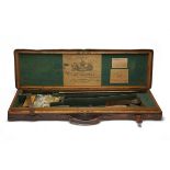 CHAS LANCASTER A BRASS-CORNERED OAK AND LEATHER SINGLE GUNCASE, fitted for 30in. barrels, the