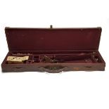 A BRASS-CORNERED LEATHER SINGLE GUNCASE, fitted for 30in. barrels, the interior lined with maroon