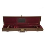 A LIGHTWEIGHT LEATHER SINGLE GUNCASE, fitted for 30in. barrels, the interior lined with red baize (