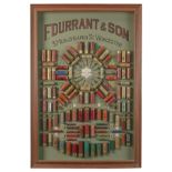 F. DURRANT & SON (WORCESTER) A GLAZED AND FRAMED SHOTGUN CARTRIDGE DISPLAY BOARD, measuring