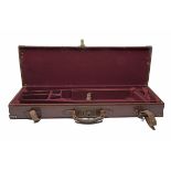 A BRASS-CORNERED LEATHER SINGLE GUNCASE WITH PROVISION FOR EXTRA BARRELS, fitted for 28in.