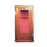 A GLASS FRONTED CORNER GUN CABINET, an eight gun safe with a walnut finish, the interior lined