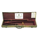 A GREEN CANVAS AND LEATHER TAKE-DOWN RIFLE CASE, fitted for a 30in. barrel (could adapt to 34in.),