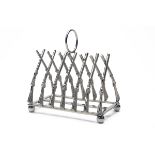 A TOAST RACK IN THE FORM OF CROSSED GUNS, the rack formed with triangulated percussion guns