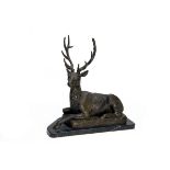 A BRONZE SCULPTURE OF A RESTING TWELVE-POINT STAG, mounted on a marble plinth, measuring approx.