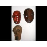 An old carved African mask with red painted decora