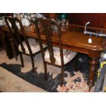 A Victorian mahogany extending dining table on tur