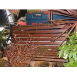 A wrought iron and wooden garden bench