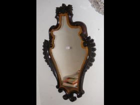 An ornate hall mirror with shaped surround