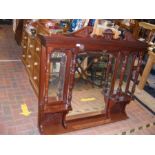 A Victorian walnut overmantel with bevelled mirror
