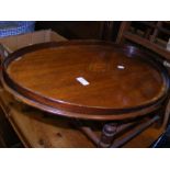 An antique oval tray with inlaid musical motif