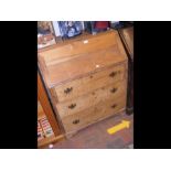 An antique pine bureau with drawers below