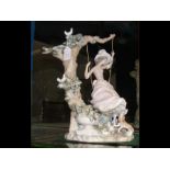 A large Lladro figure of girl on swing with doves