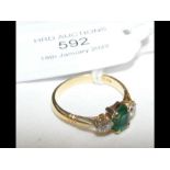 A 14ct diamond and emerald ring - size M