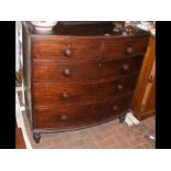 A bow front chest of drawers