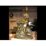 A table lamp in the form of a bronzed statuette of