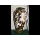 A Moorcroft Pottery vase with tube lined floral de