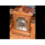 An antique style mantel clock in wooden case