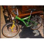 An Apollo 'Ruthless' Boys mountain bike in green, Y frame, Shimano gears