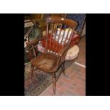 An antique stick back country armchair