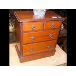 A miniature chest of two short and two long drawer