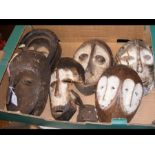 Six old carved African masks (varying condition)