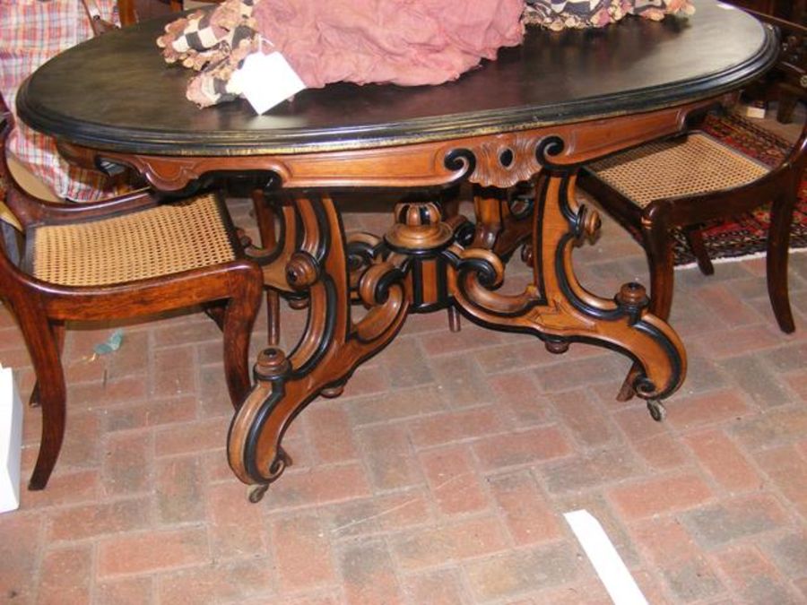 A 19th century oval dining table with shaped suppo