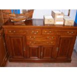 An Edwardian mahogany sideboard with cross banded