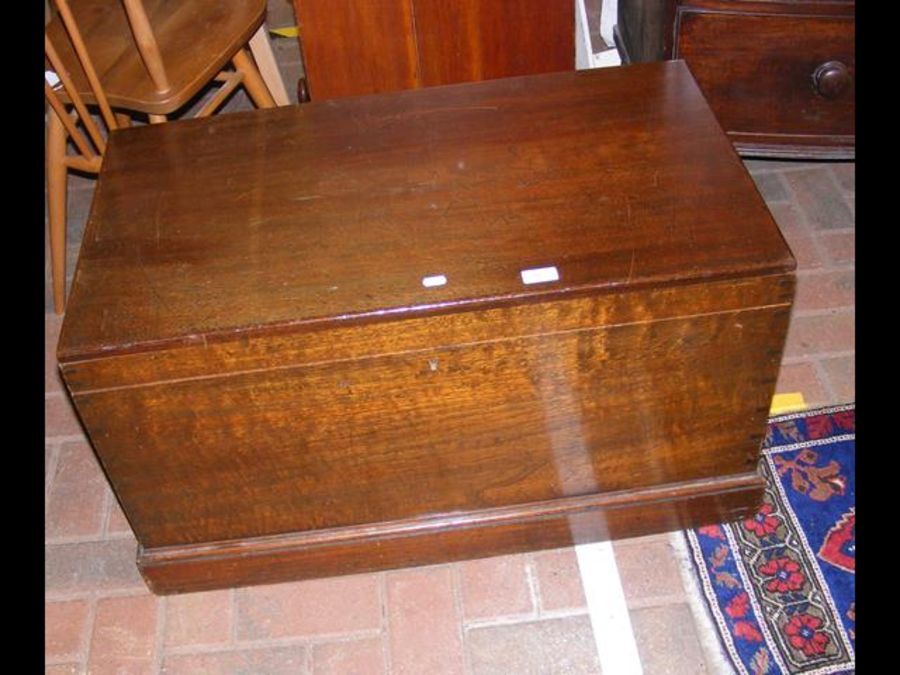 An antique sea chest with fitted interior and hand