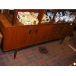 A retro teak sideboard with central drawers flanke